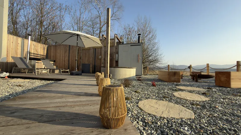 Johanka glamping terrace with loungers and parasol — blue sky