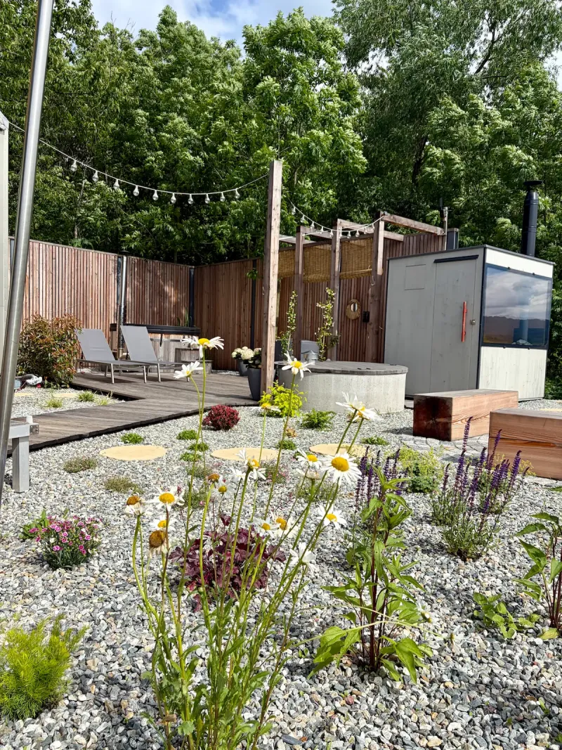 Johanka Hutka in summer — off-grid tiny house glamping with daisies and solar panels, Rychlebské hory mountains