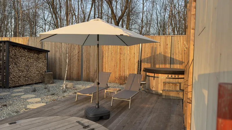 Sun loungers under parasol on the deck at sunset