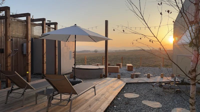 Sunset over the wellness area at winter's end — Johanka glamping